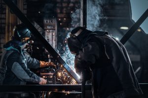 Man is working at the busy metal factory